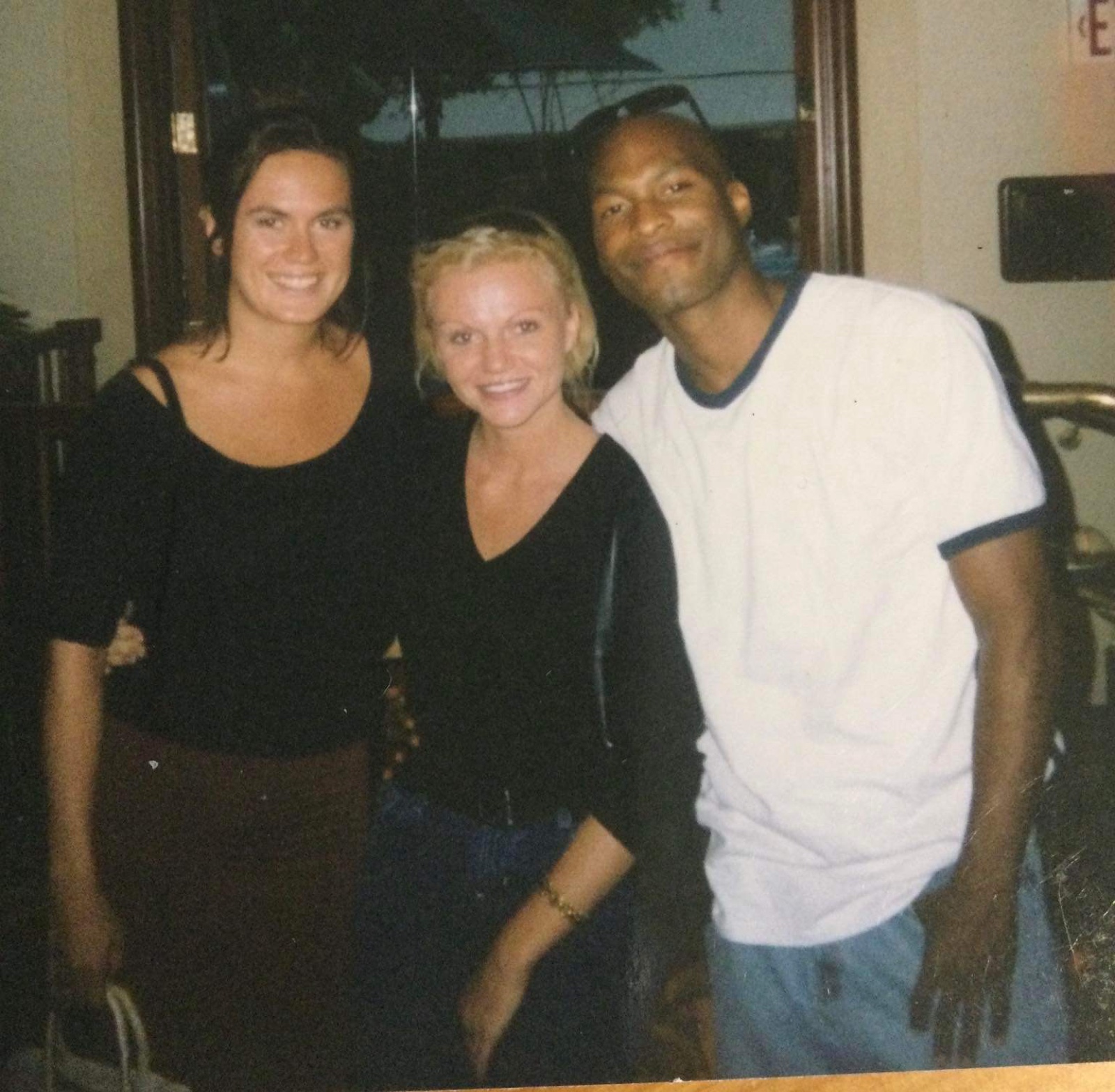 Alysha smiling between two friends
